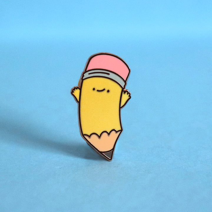 Pencil enamel pin on blue background