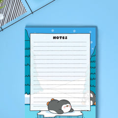 A6 Penguin Notepad on blue desk close up
