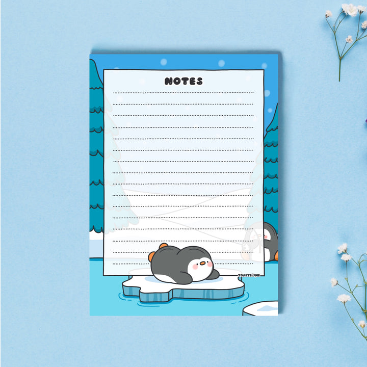 A6 Penguin Notepad on blue table 