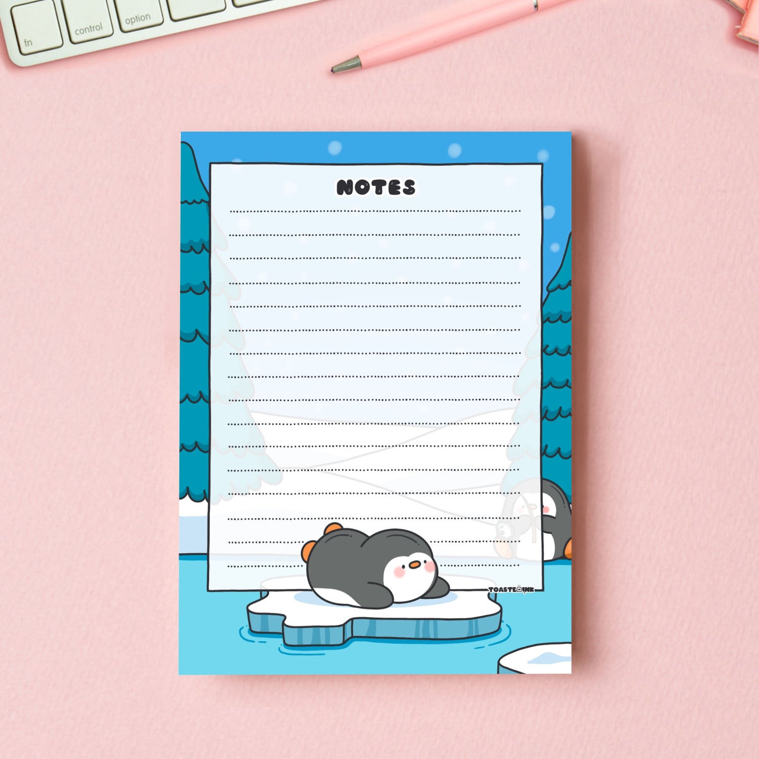 A6 Penguin Notepad on pink table with keyboard