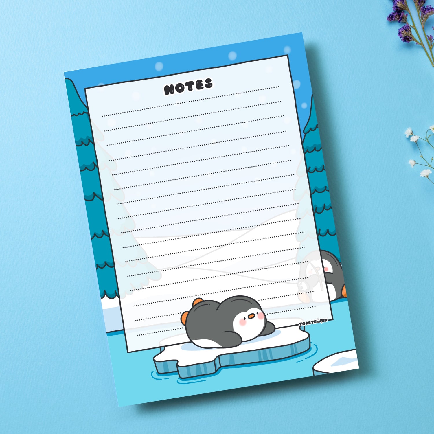A6 Penguin Notepad on blue table with flowers