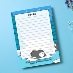 A6 Penguin Notepad on blue table with flowers