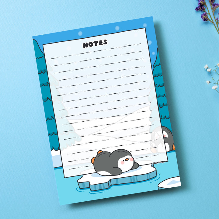 A6 Penguin Notepad on blue table with flowers