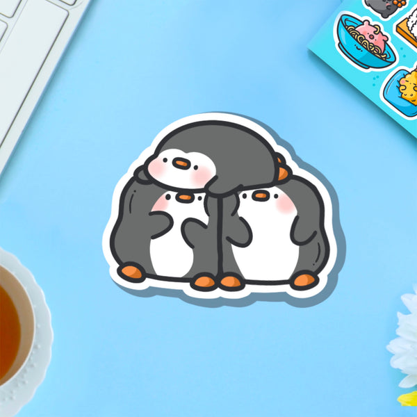 Three penguins vinyl sticker on blue background