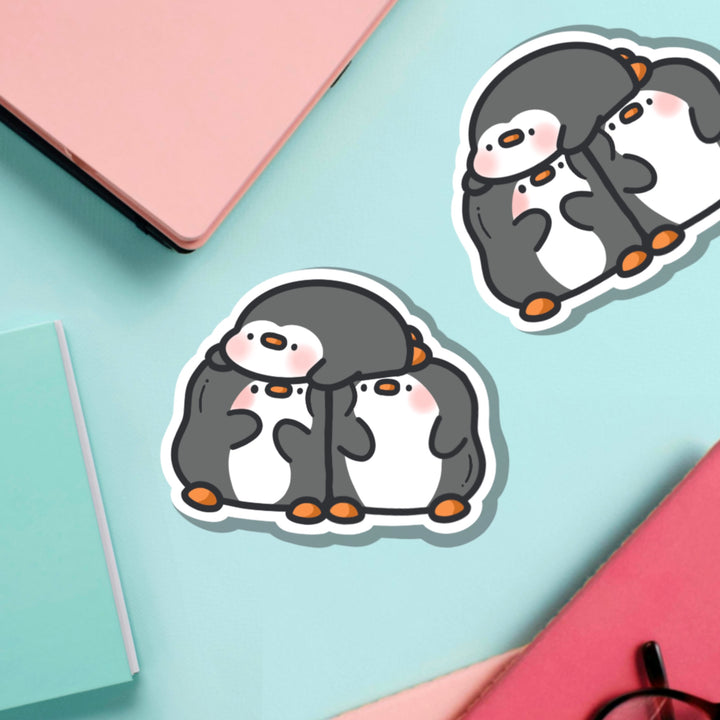 Three penguins vinyl sticker on green table