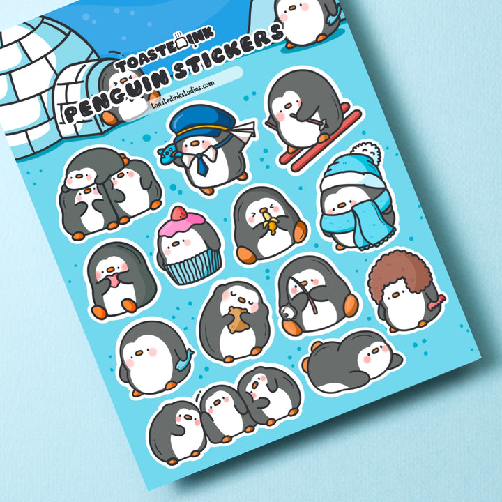 Penguin sticker sheet on turquoise table