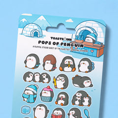 Penguin sticker sheet close up on blue desk