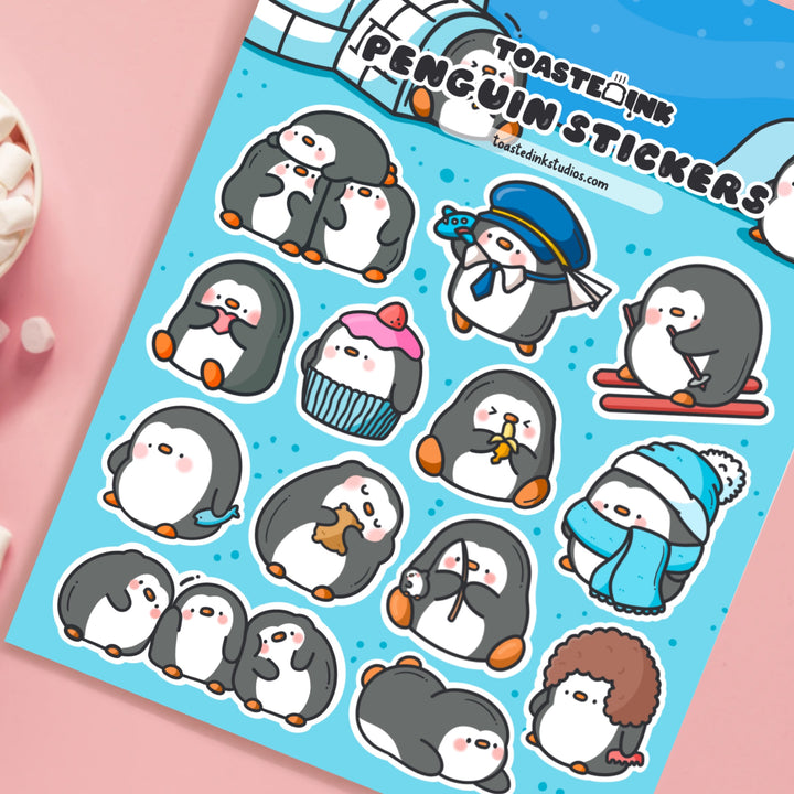 Penguin sticker sheet close up on pink desk