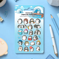 Penguin sticker sheet on table scattered with stationery