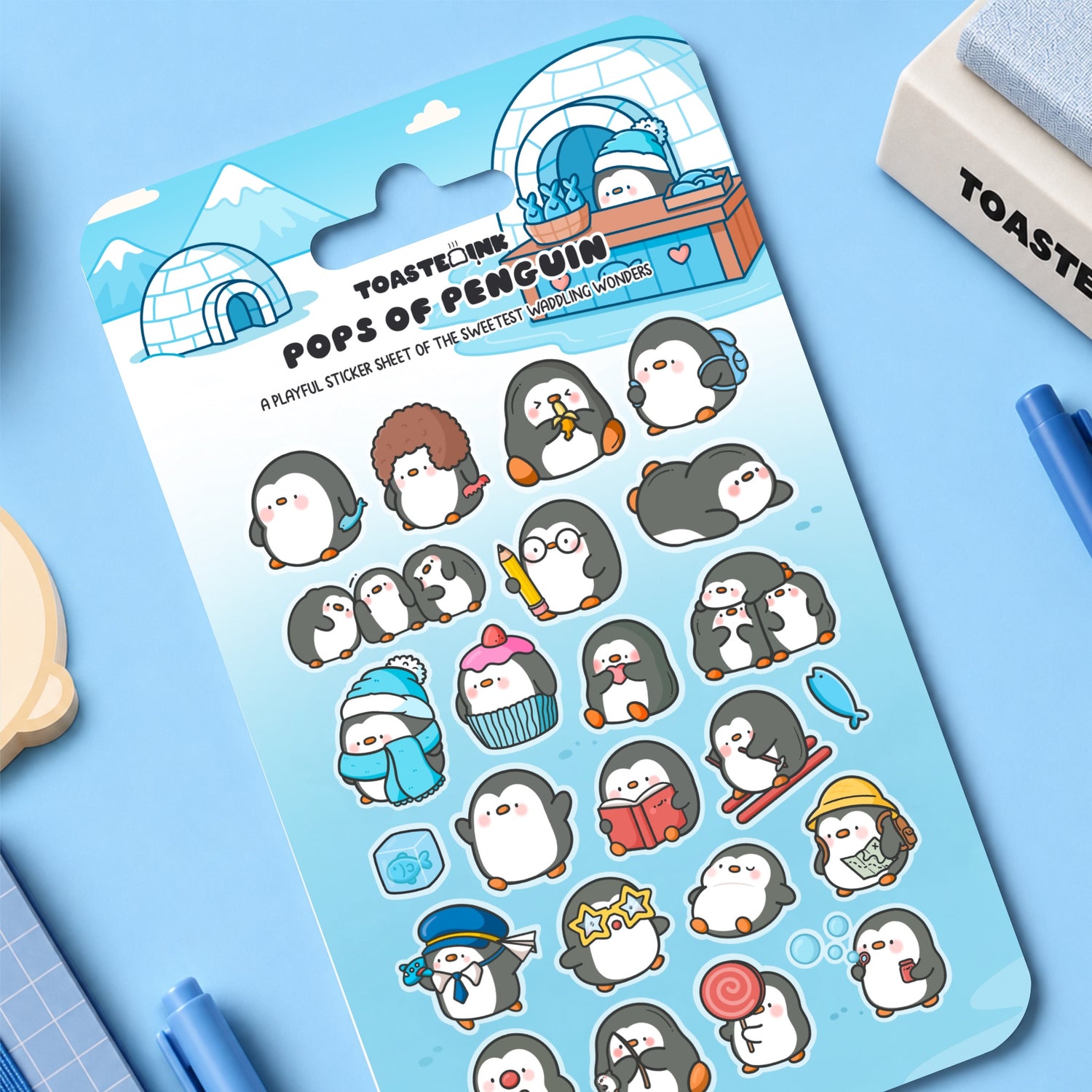 Penguin sticker sheet on desk with stationery