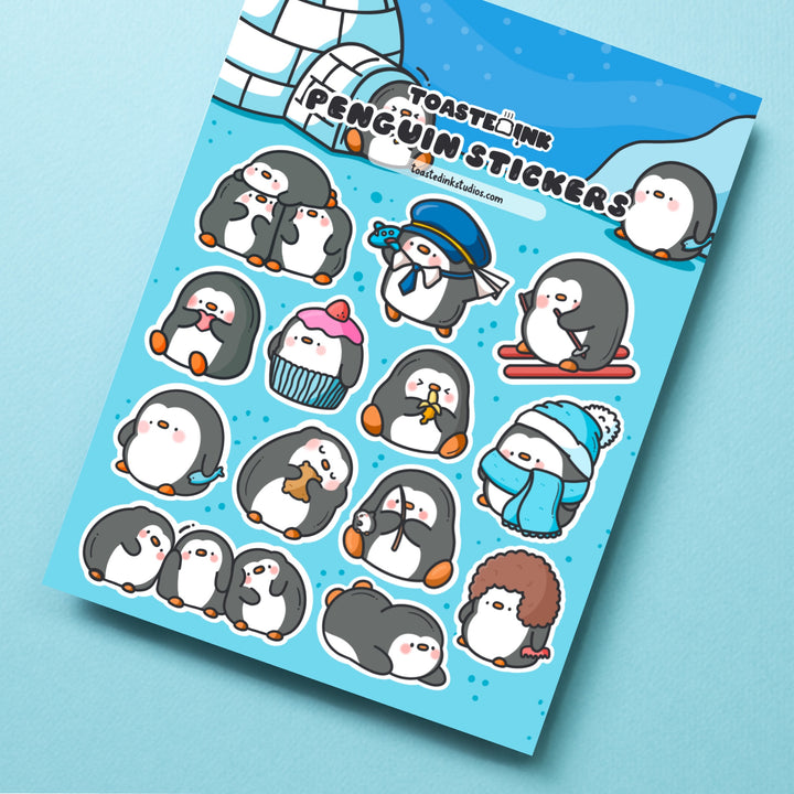 Penguin sticker sheet close up on blue desk