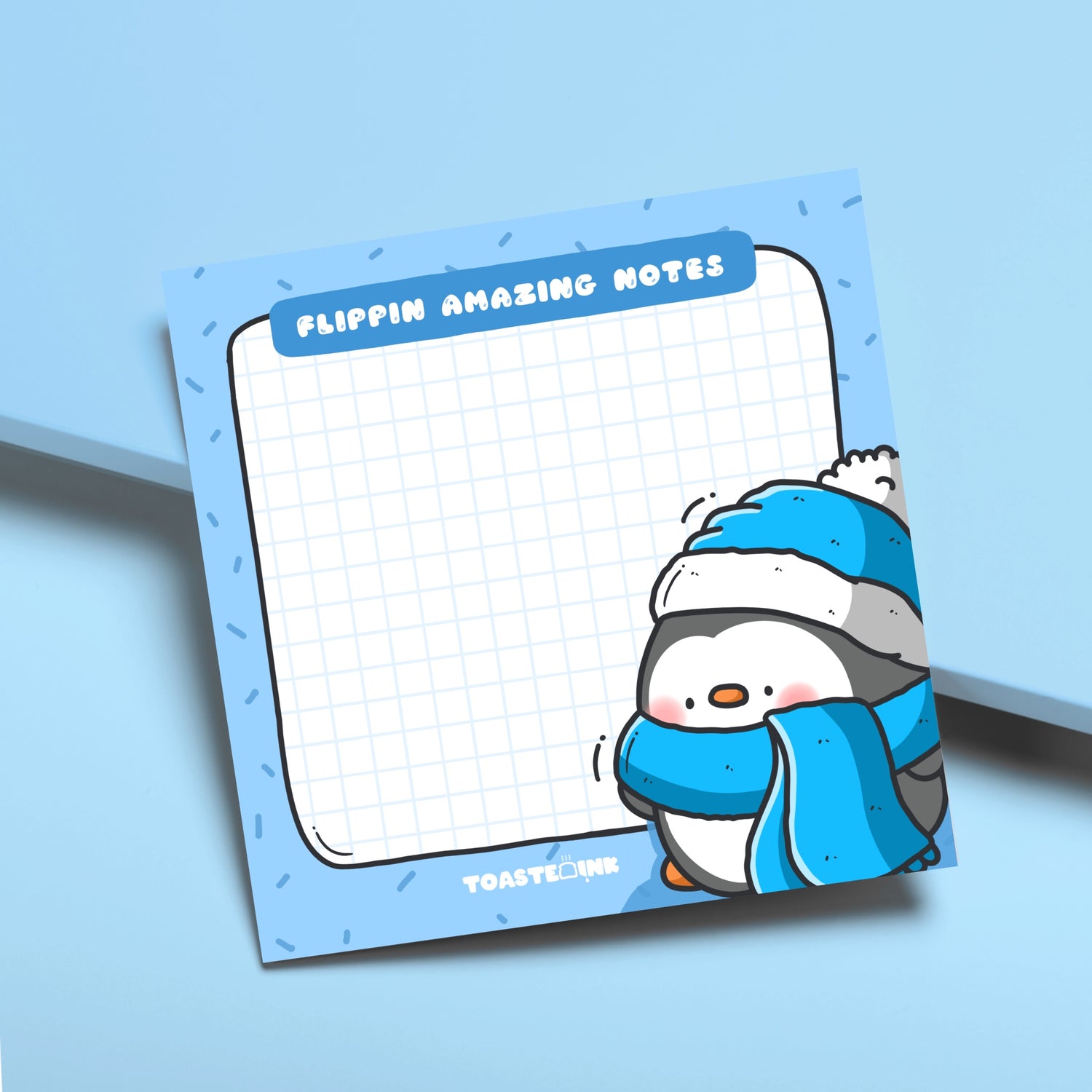 Penguin sticky notes on blue desk