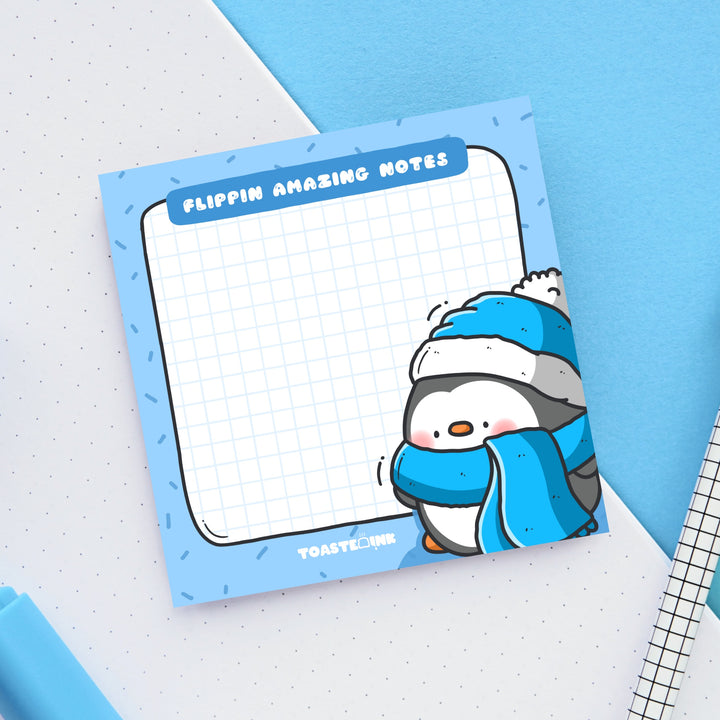 Penguin sticky notes on blue and white table