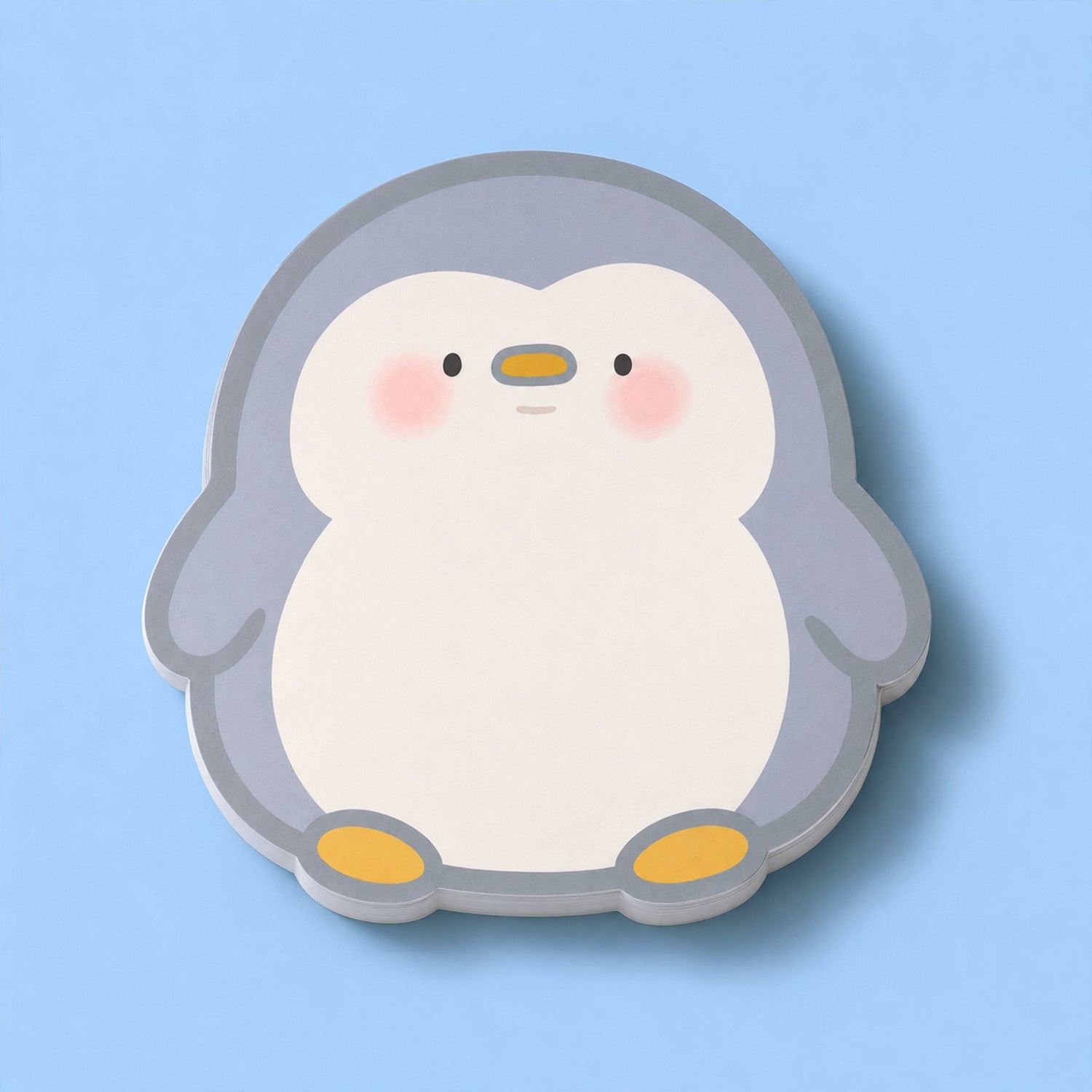 Penguin shaped sticky notes on blue table