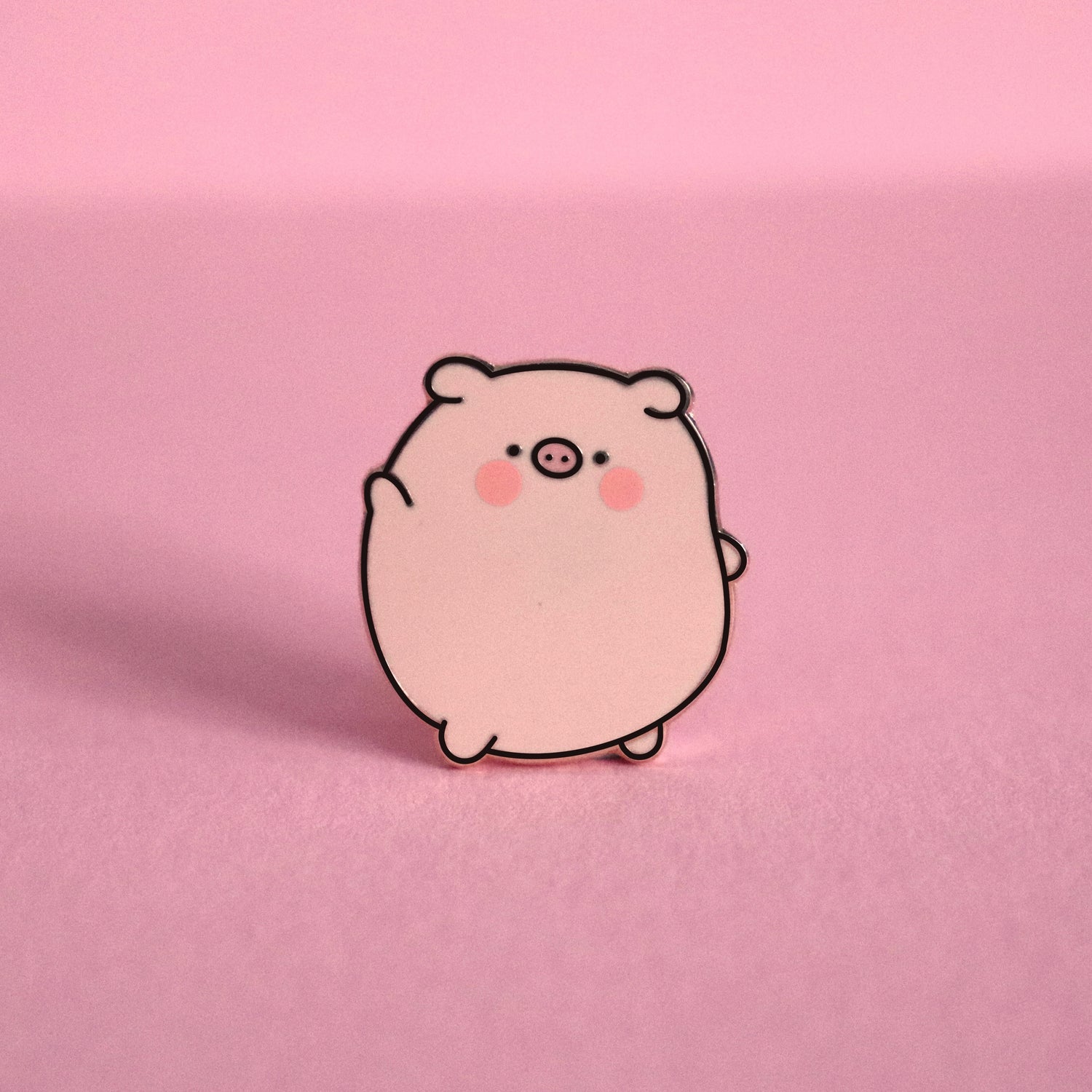 Pig enamel pin on pink desk