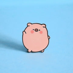 Pig enamel pin on blue background