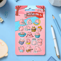 Pig sticker sheet on blue desk with scattered stationery