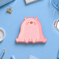 Pig shaped sticky notes on blue desk with stationery