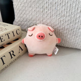 Pig keychain plush on beige table