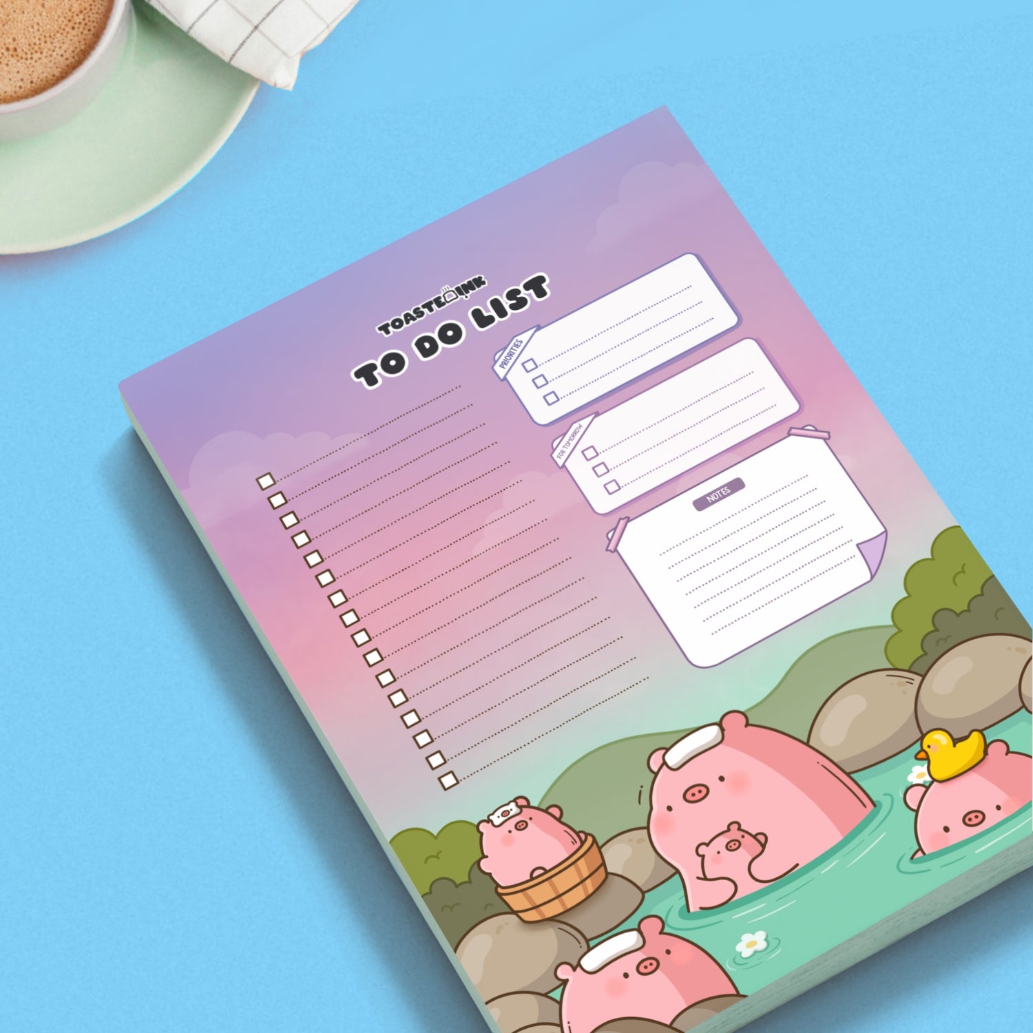 Pig to do list notepad on blue desk with mug of coffee