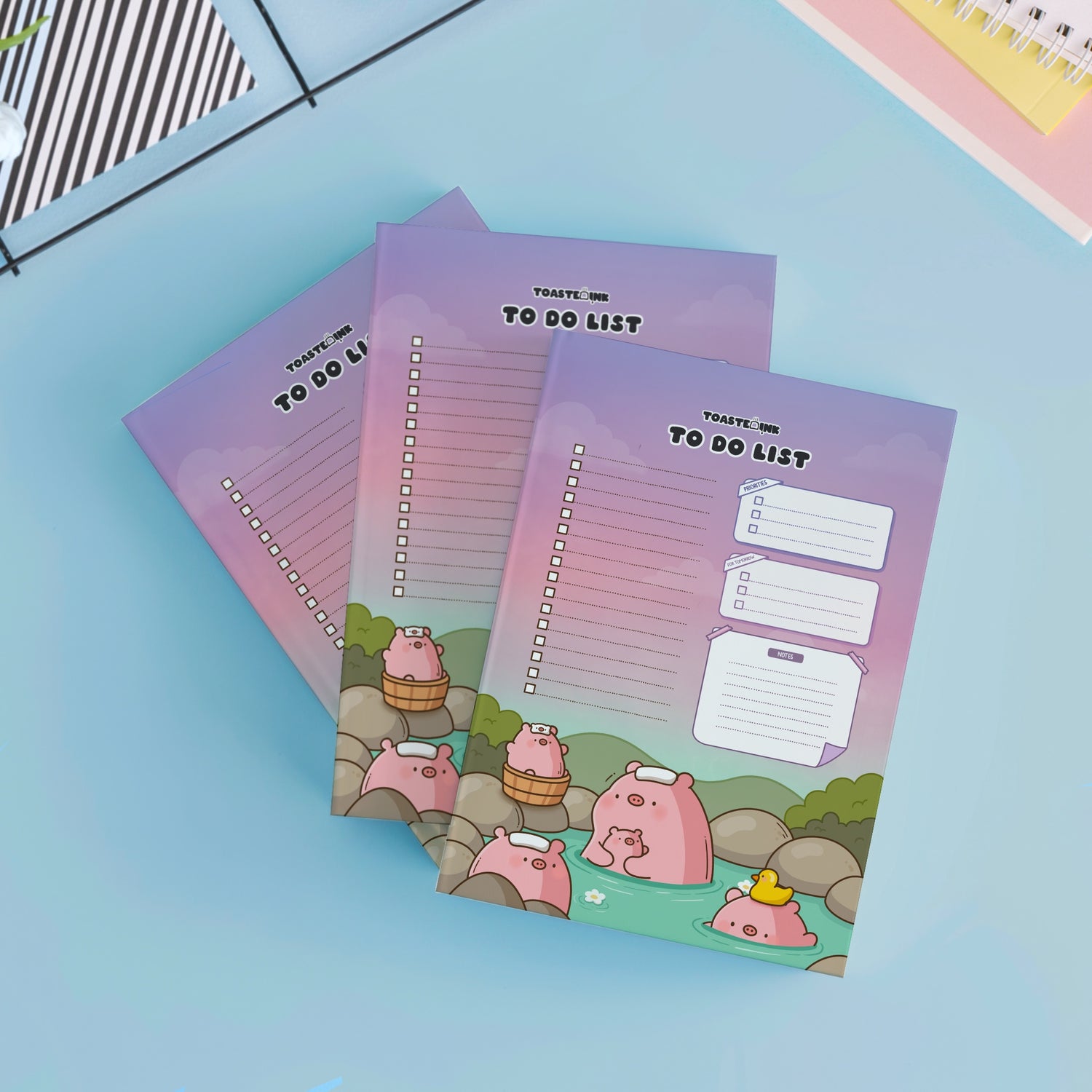 Three pig to do list notepads on desk with notebooks