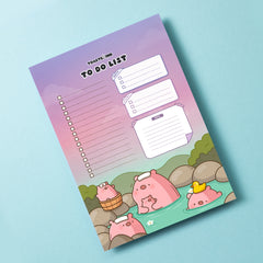 Pig to do list notepad on blue desk