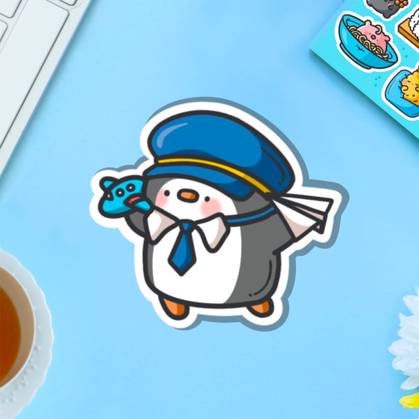 Pilot penguin vinyl sticker on blue table