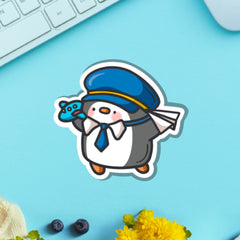 Pilot penguin vinyl sticker on green table