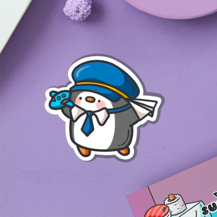 Pilot penguin vinyl sticker on purple table