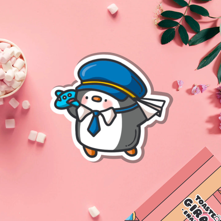 Pilot penguin vinyl sticker on pink table