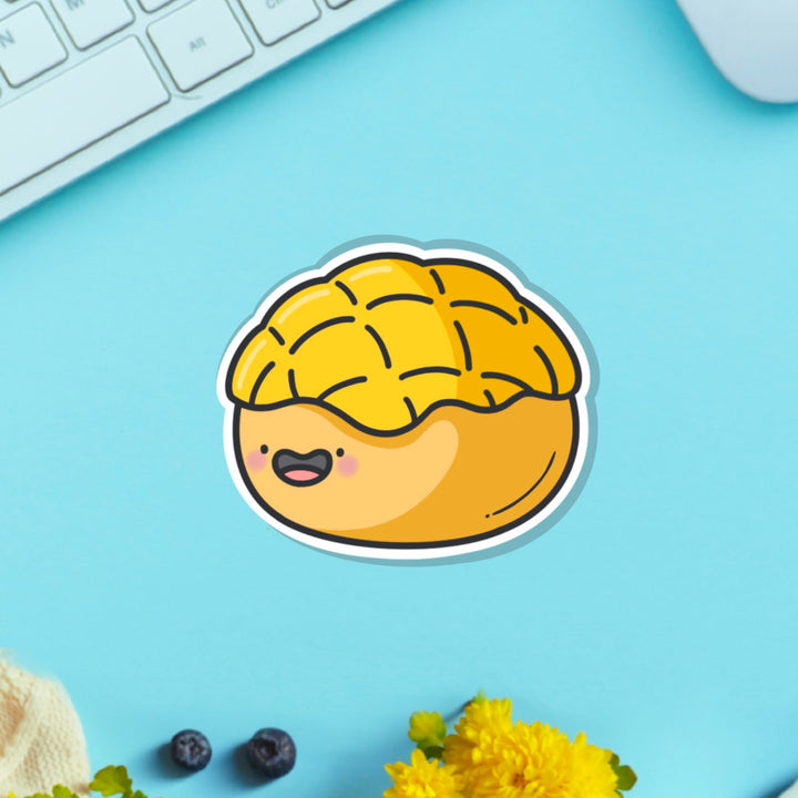 Pineapple bun vinyl sticker on blue table with keyboard