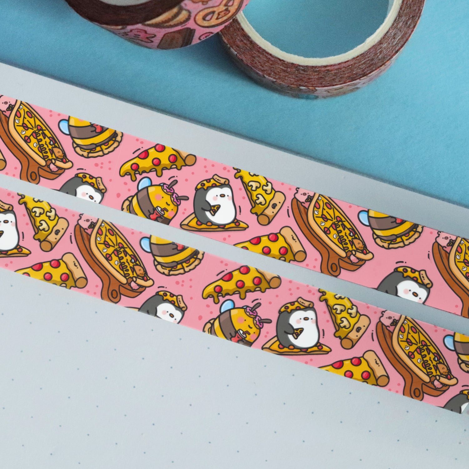 Pizza washi tape stuck on notebook and blue table