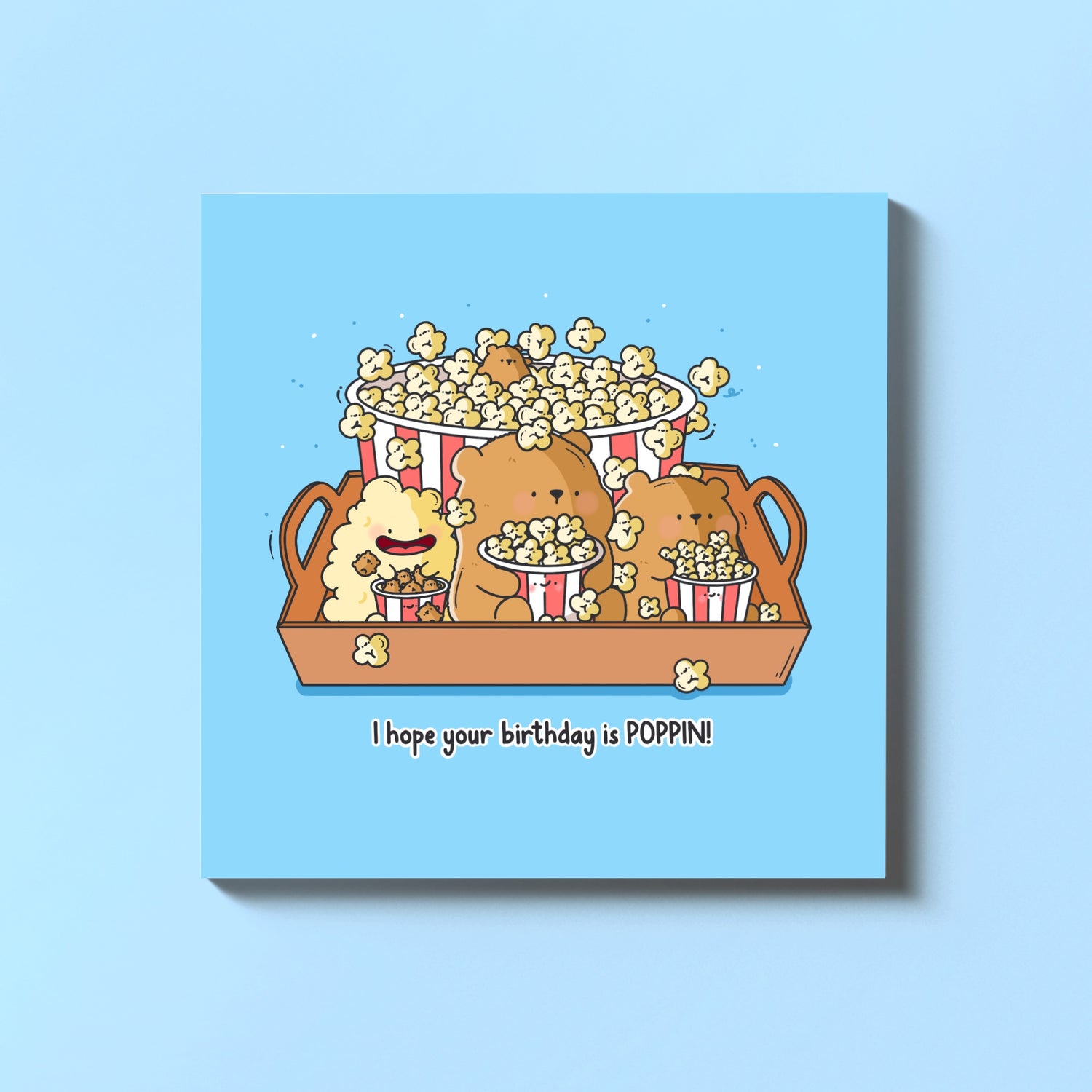 Popcorn bear birthday card on blue table