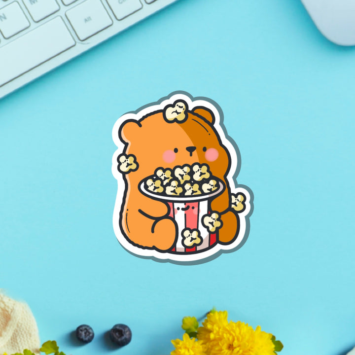 Bear with popcorn vinyl sticker on green table