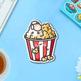 Sheep in popcorn vinyl sticker on blue table