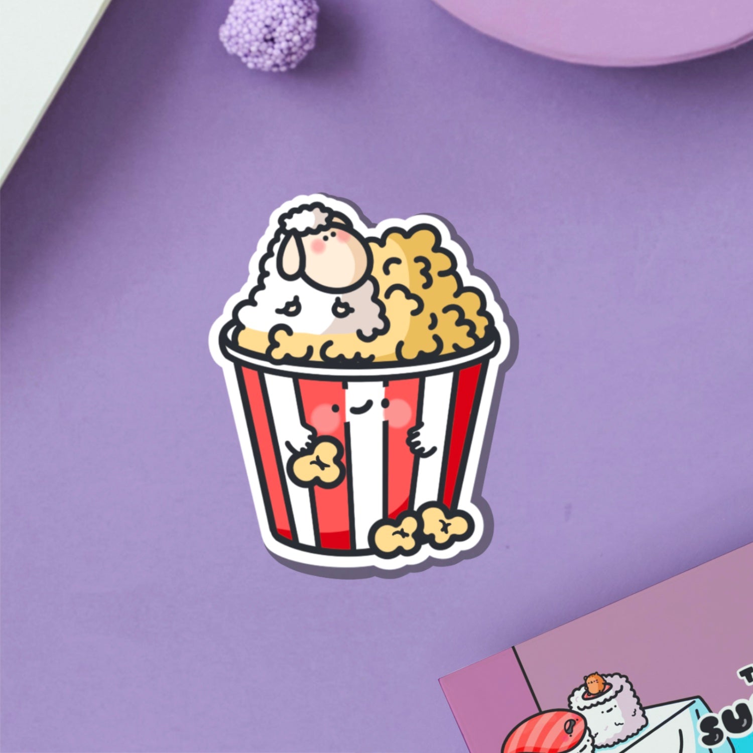 Sheep in popcorn vinyl sticker on purple table