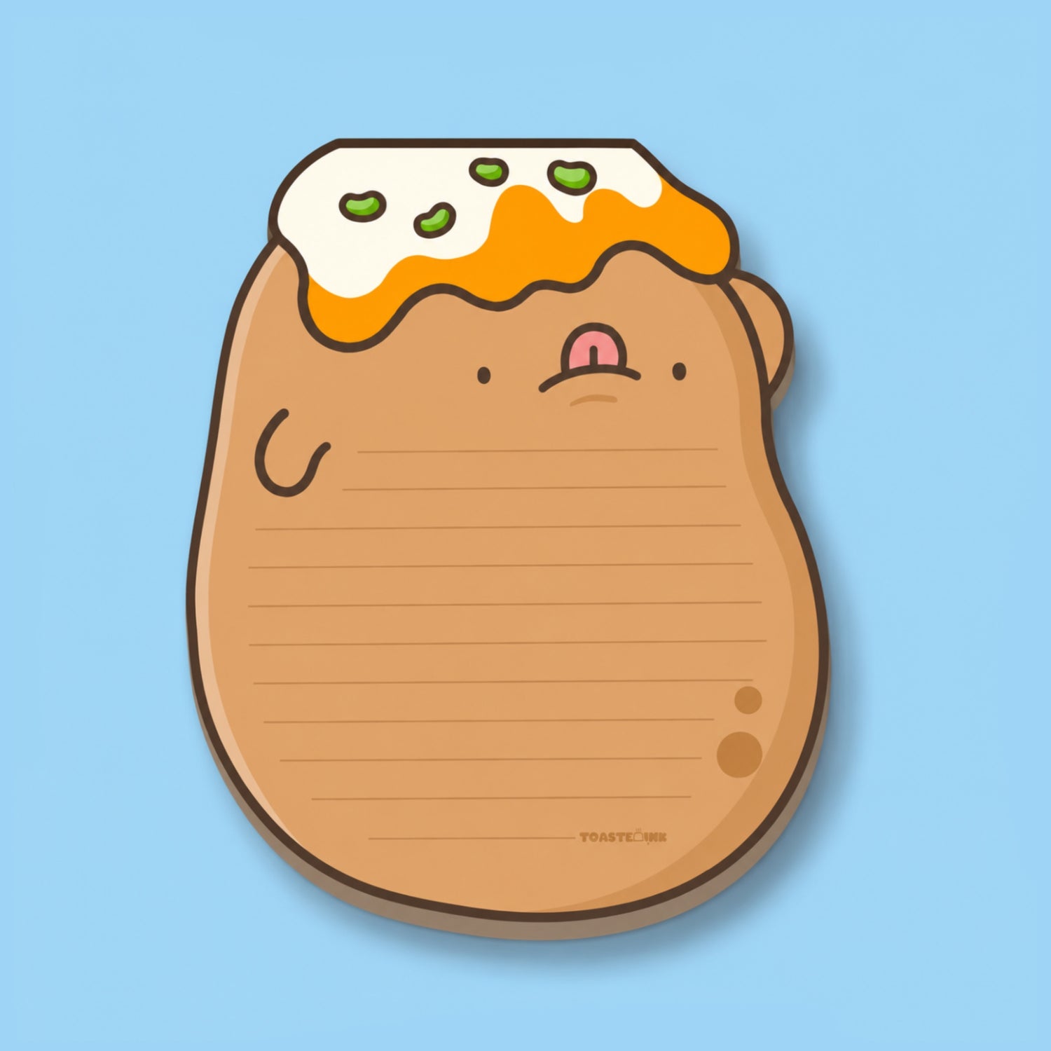 A cute potato-shaped notepad with a smiling face, topped with white cream and green toppings, shown on a light blue background.