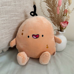 Potato plush toy with beige cushion and flowers
