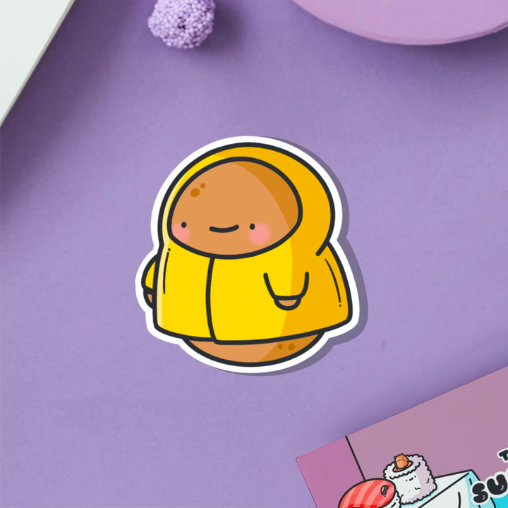 Potato in a raincoat vinyl sticker on purple table