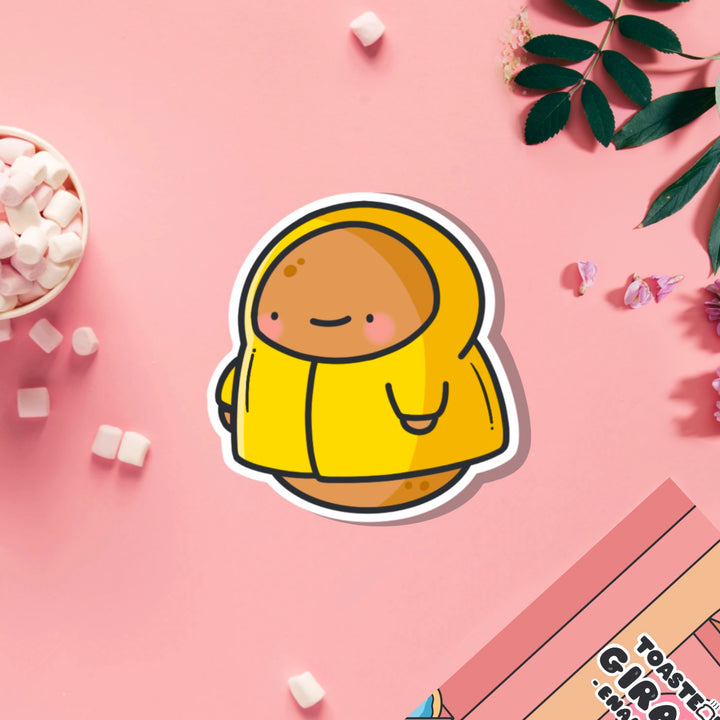 Potato in a raincoat vinyl sticker on pink table