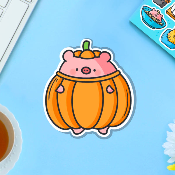 Pig dressed as pumpkin vinyl sticker on blue table