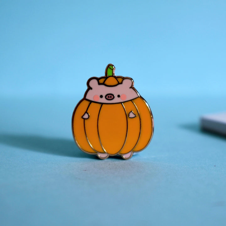 Pumpkin pig pin on blue table