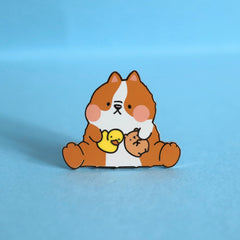 Dog Enamel pin on blue table
