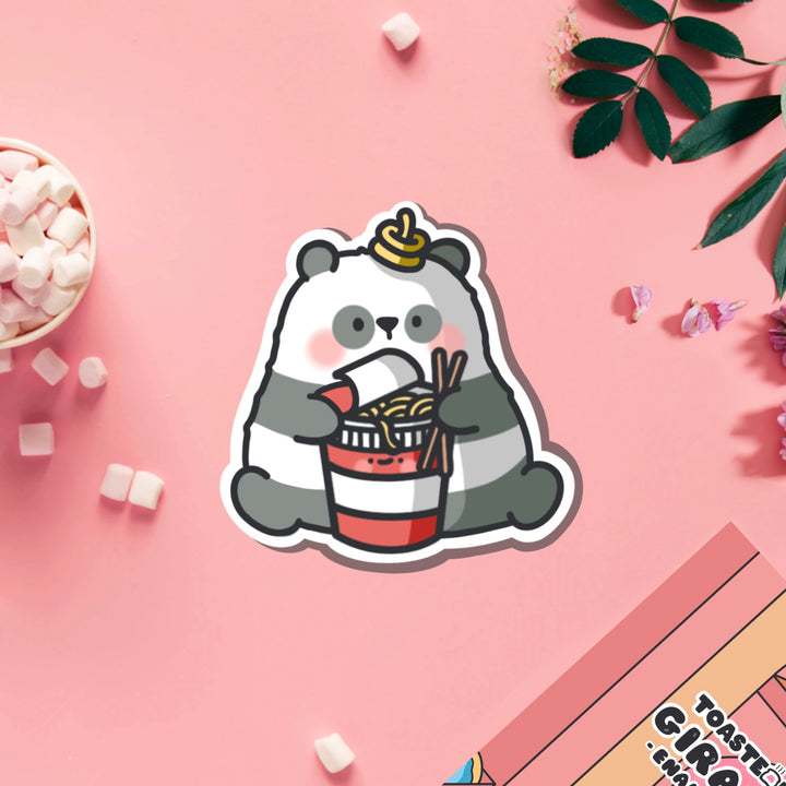 Panda holding ramen vinyl sticker on pink table