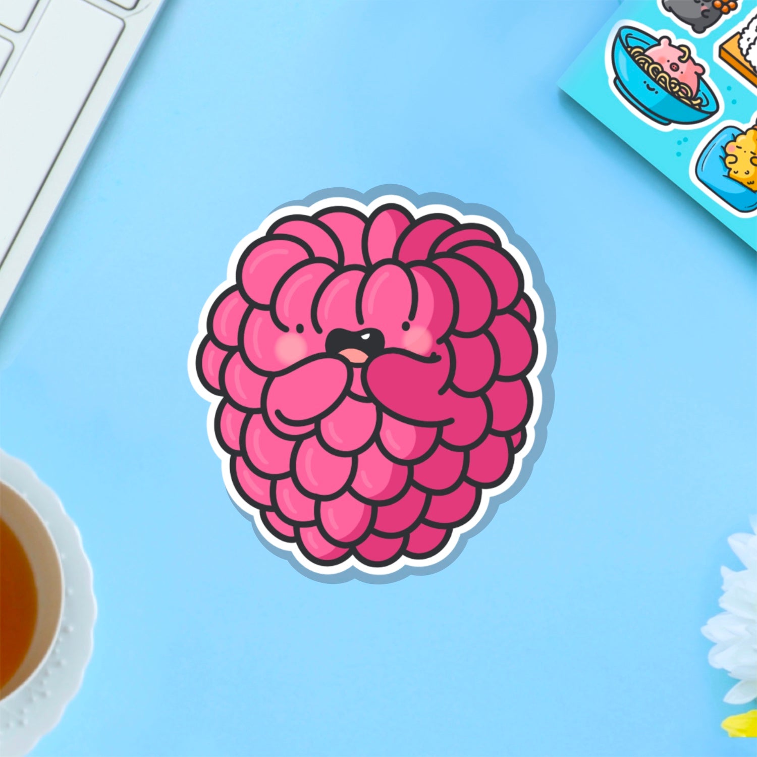 Raspberry vinyl sticker on blue table
