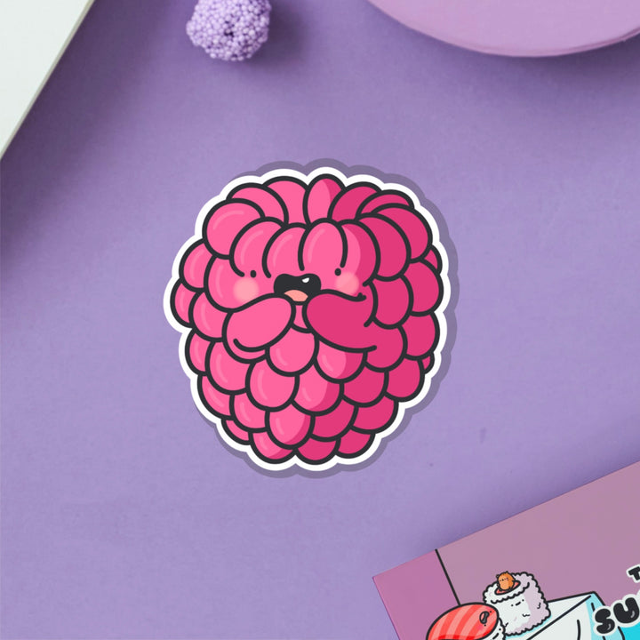 Raspberry vinyl sticker on purple table