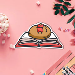 Reading potato vinyl sticker on pink table