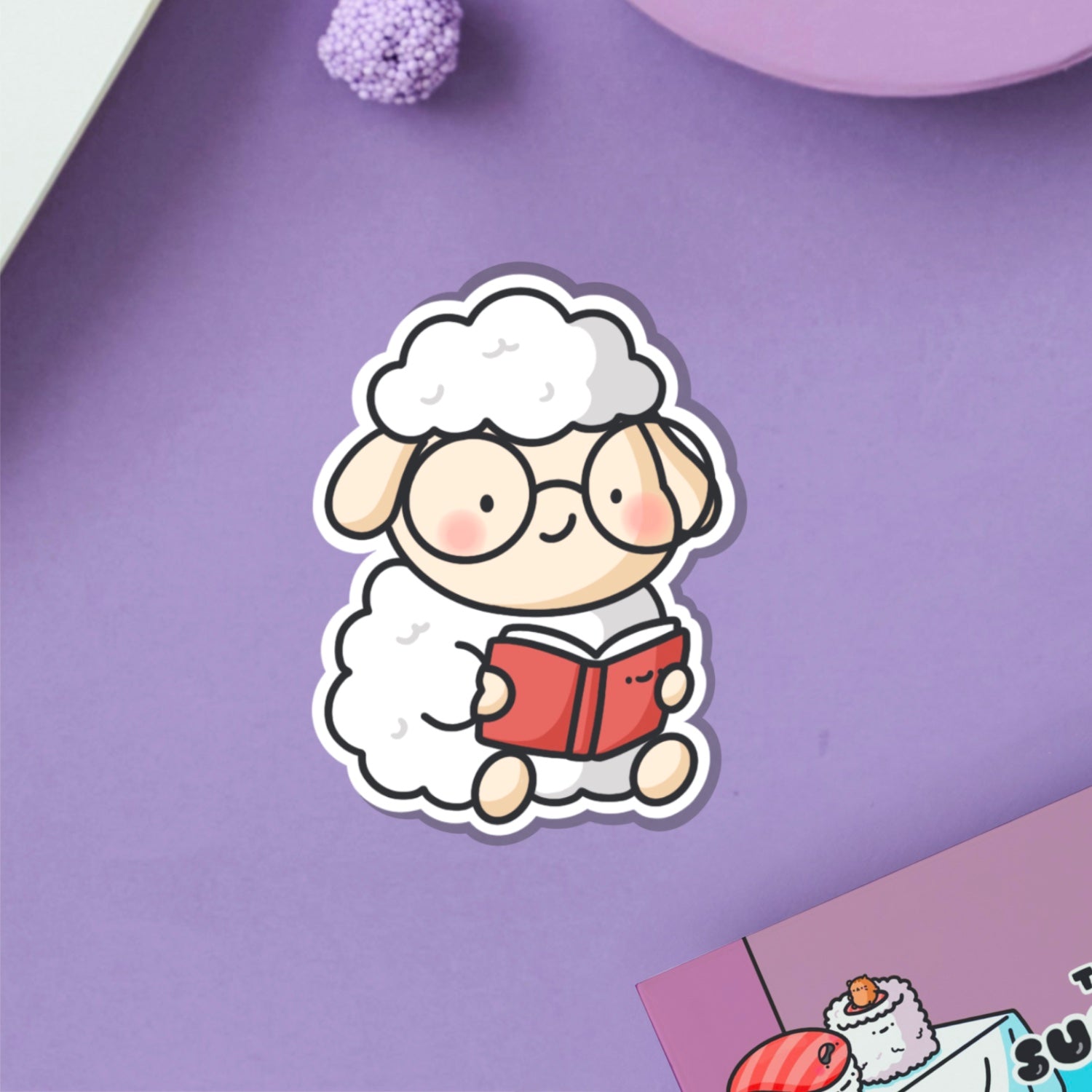 Reading sheep vinyl sticker on purple table