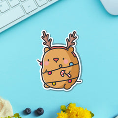 Bear as reindeer vinyl sticker on blue table with keyboard