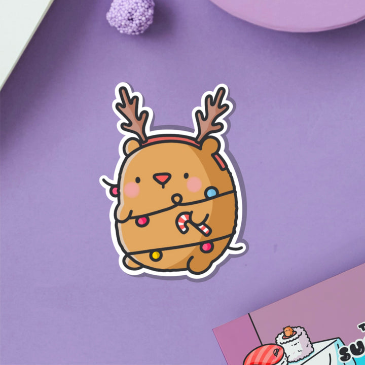 Bear as reindeer vinyl sticker on purple table